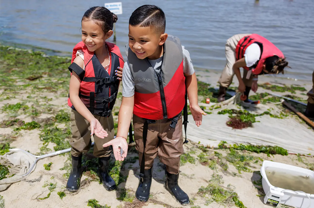 Photo of two children seining on the York River.