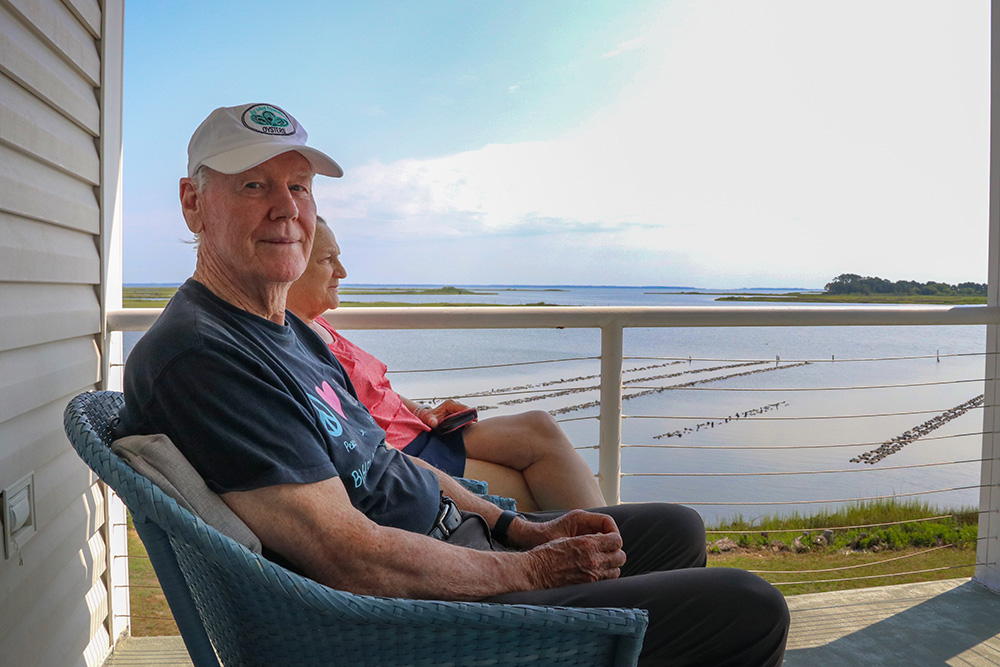 Bruce Vogt and his wife Cathy sit on the balcony overlooking their farm. Photo by John Wallace.