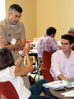VIMS graduate student Ike Irby (R) discusses flooding issues with fellow conference attendees.
